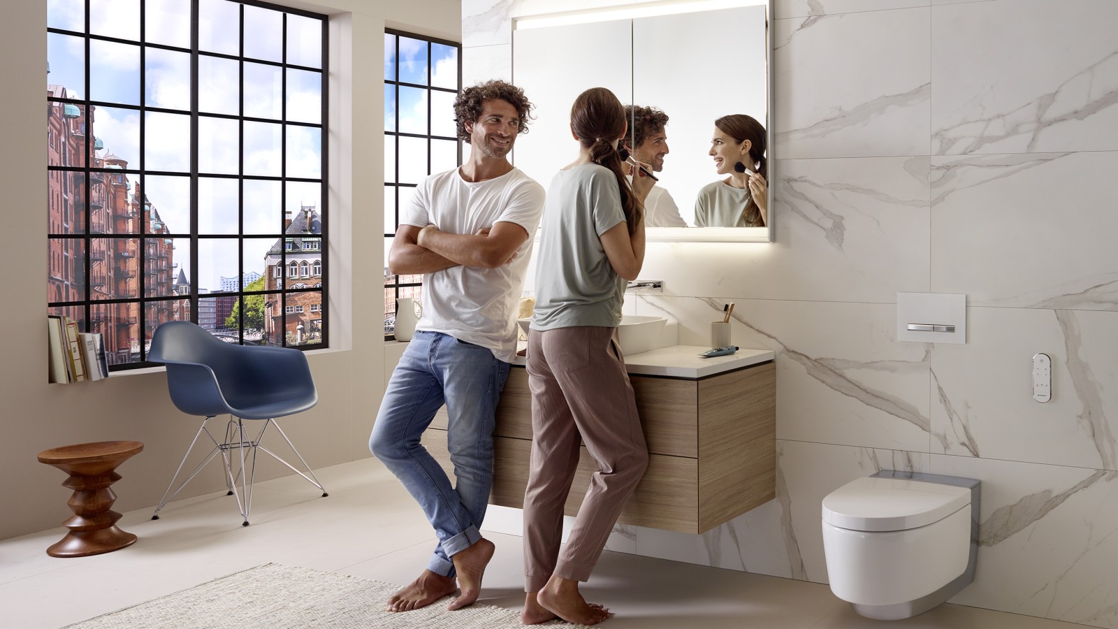 Couple in an apartment bathroom with wall-hung fixtures Couple in an apartment bathroom with wall-hung fixtures