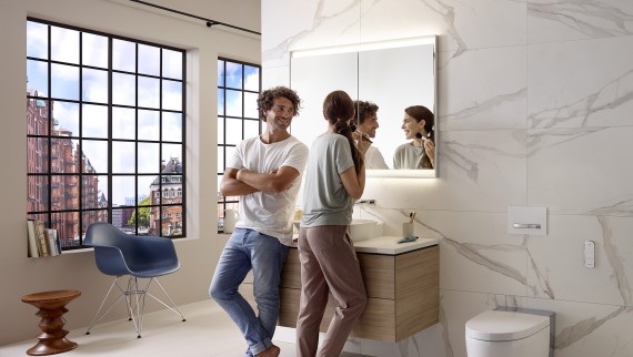 Couple in an apartment bathroom with wall-hung fixtures